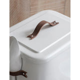 White container with a brown handle on a wooden surface